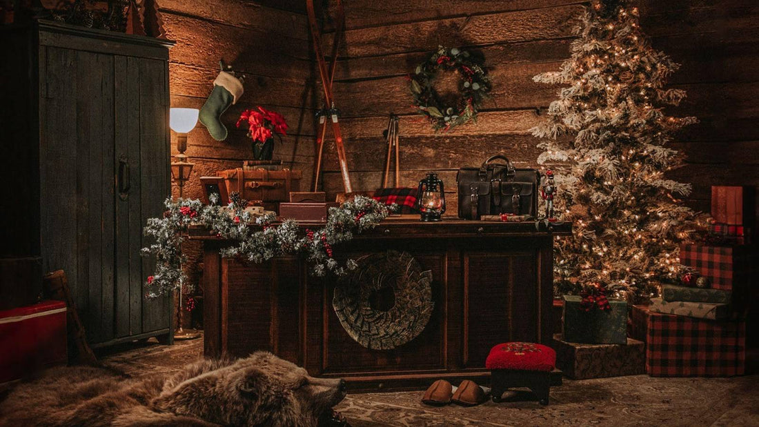 Rustic cabin scene with a lit Christmas tree, wreath, stocking and a leather briefcase on a wooden counter
