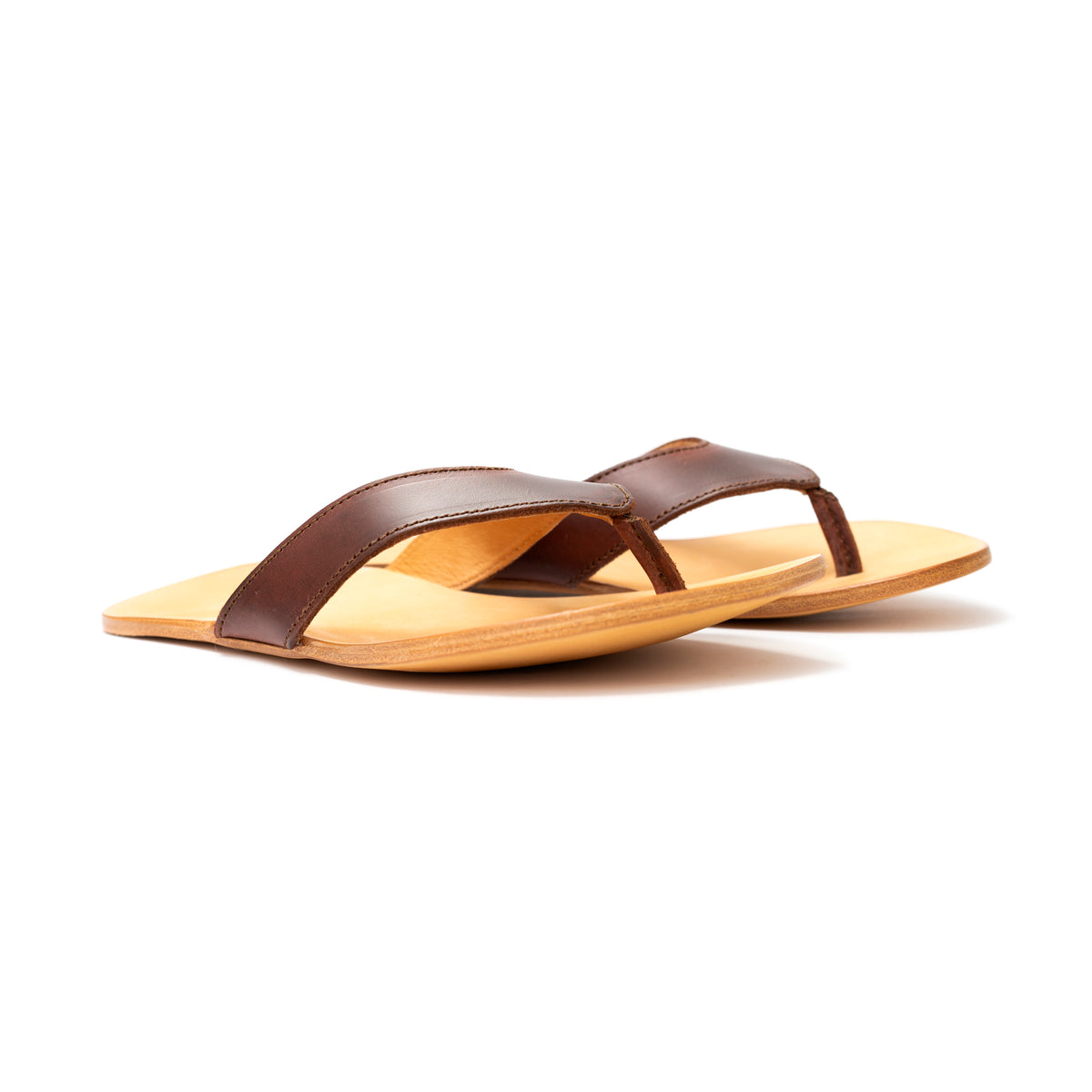 Pair of Flip Flops in Chestnut leather with natural footbeds, low side angle view