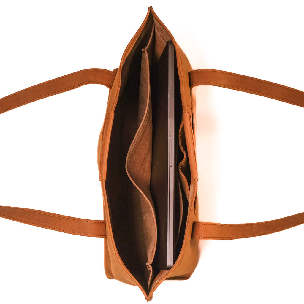 Urban Leather Tote in Tobacco, top view open showing a laptop in the padded sleeve and interior pockets