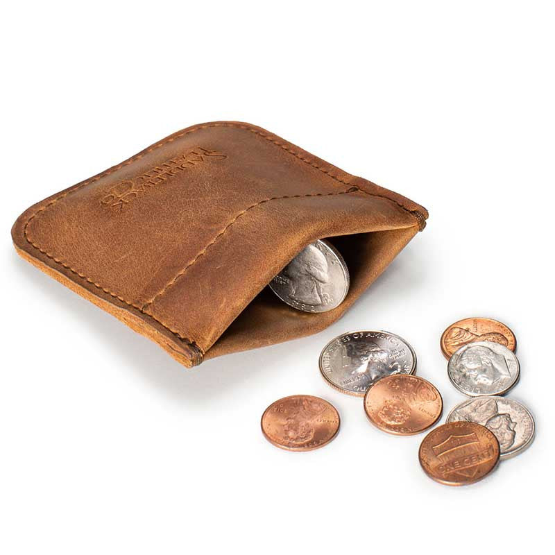 Bear Trap Leather Coin Purse in Tobacco squeezed open to show coins inside, with coins beside it