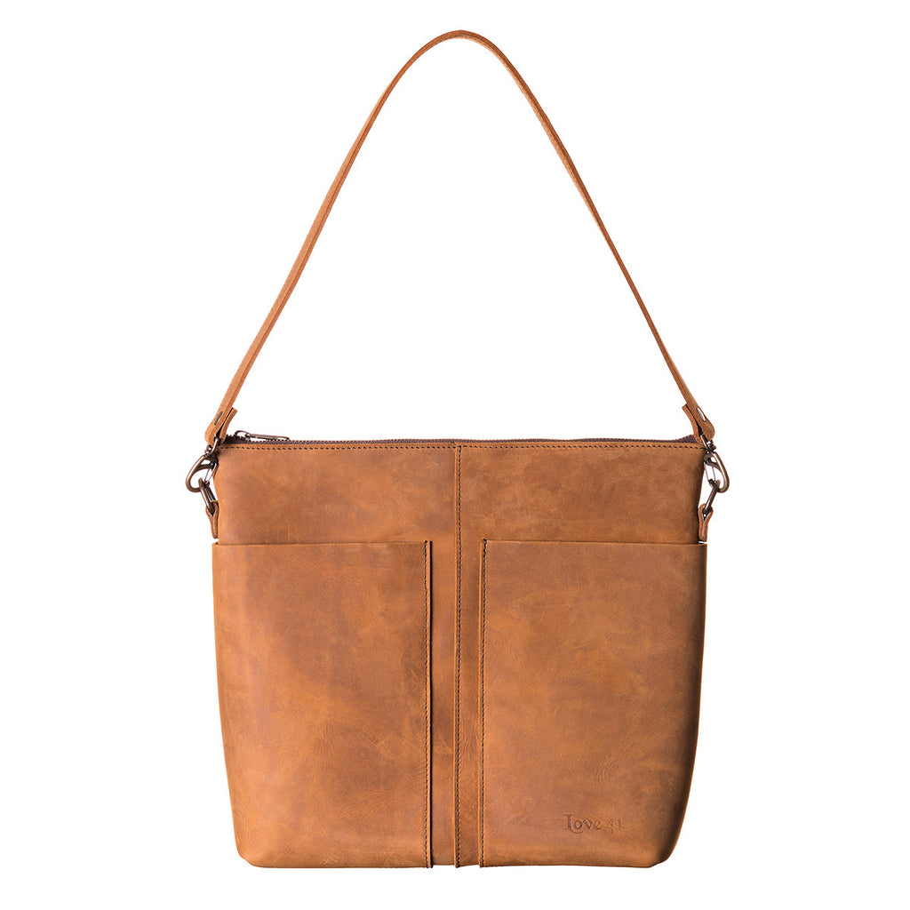 Minimal Leather Bag in cognac, front view with stamped logo, two slip pockets and shoulder strap