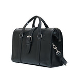 Spurgeon Briefcase in Raven Black, angled side view showing the buckle strap and shoulder strap clip