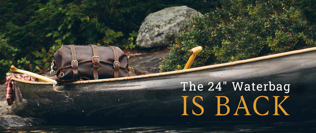 Dark brown 24 inch leather Waterbag strapped in a canoe on a lake, with text: The 24" Waterbag is back
