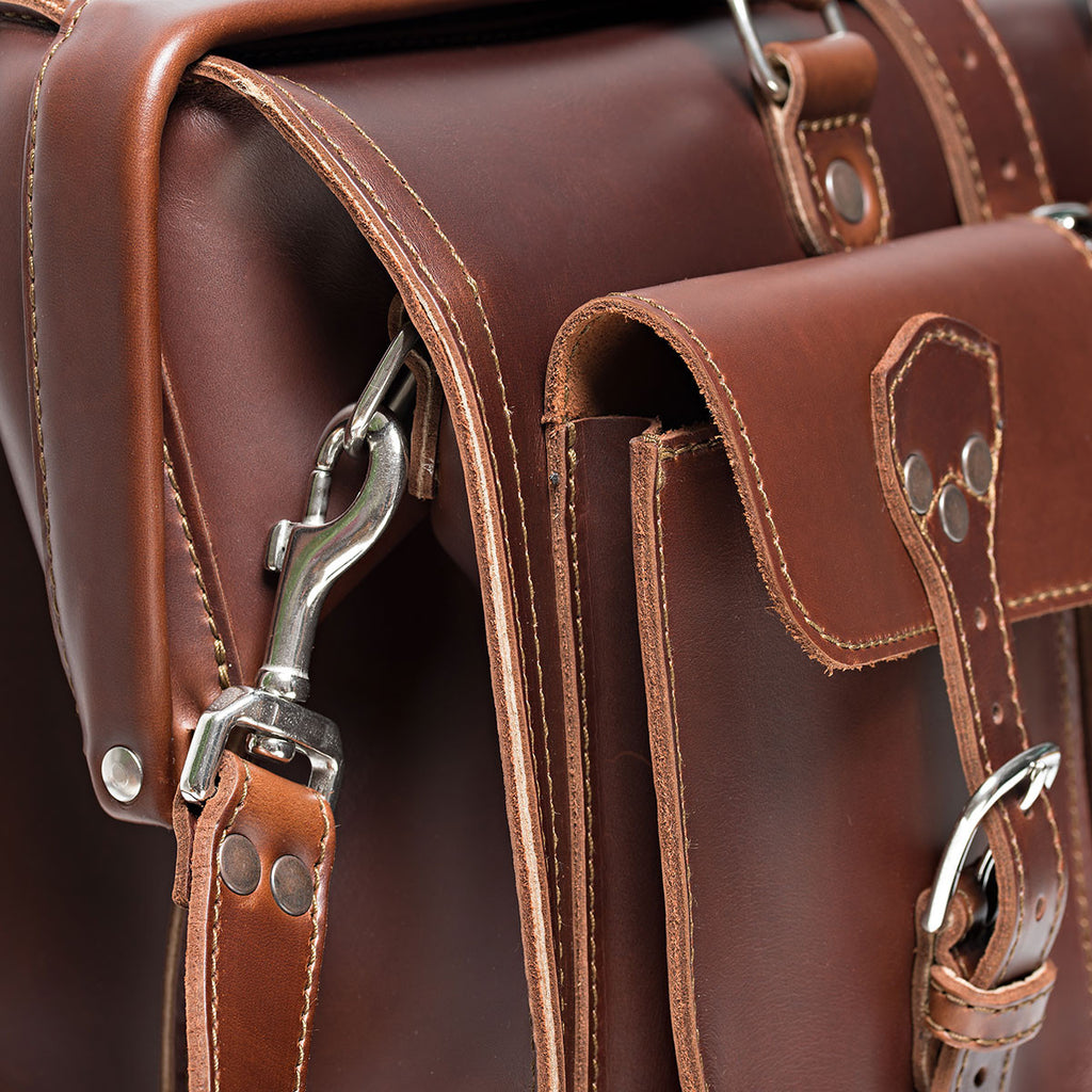 Barrister's Briefcase in Chestnut, close-up of the buckled front pocket, stitching and swivel strap clip