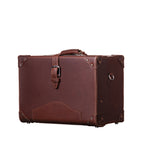 Grandfather Overnight Case in Chestnut, angled front view with top handle, buckled strap and metal corner caps