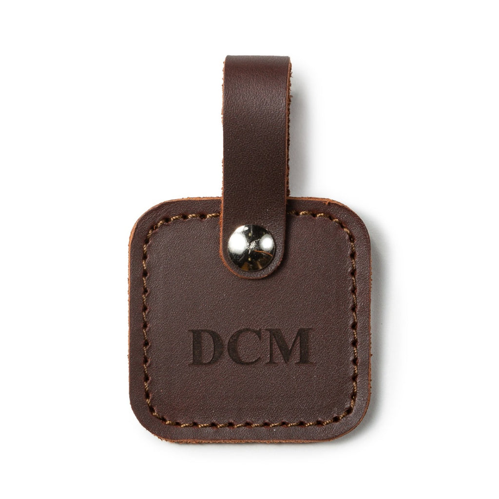 Leather Bag Tag in Chestnut with snap strap, personalized with an engraved DCM monogram