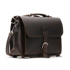 Slim Leather Briefcase in Dark Coffee Brown, angled front view with buckled flap, top handle and shoulder strap