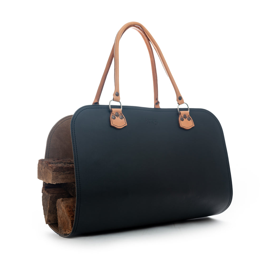 Leather Log Carrier in Black with tan carry handles, holding firewood, side view