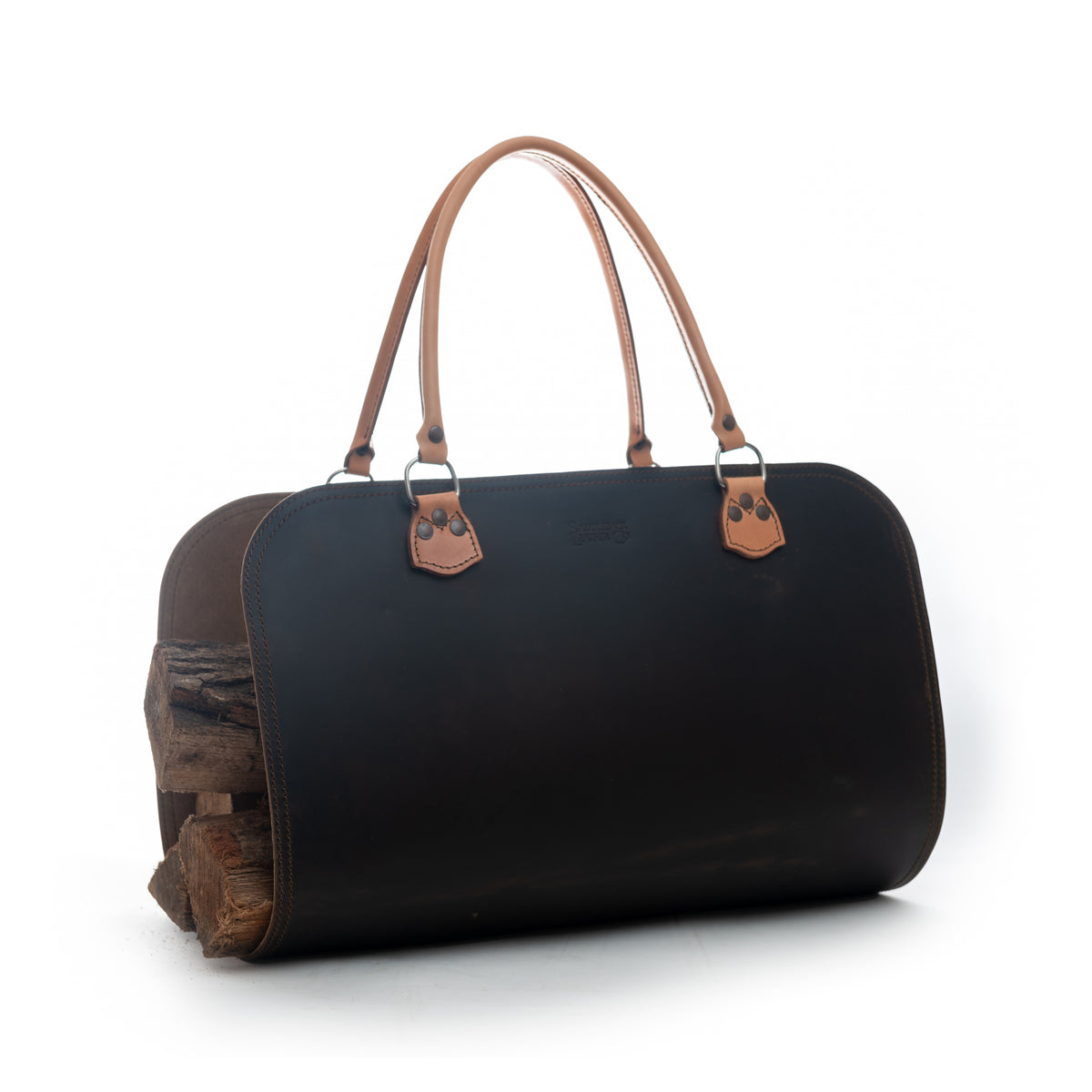 Leather Log Carrier in Dark Coffee Brown with tan carry handles, holding firewood, side view