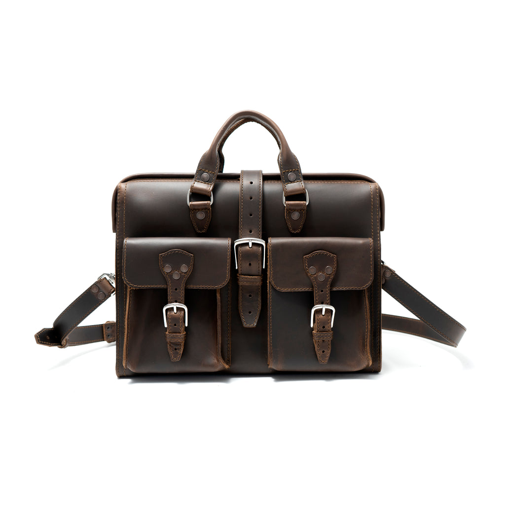 Flight Bag Leather Briefcase in dark brown, front view with two buckled pockets, top handles, and shoulder strap