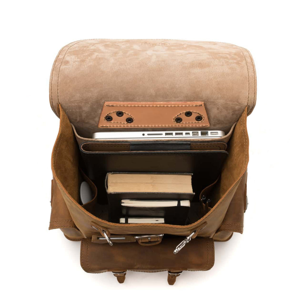 Front Pocket Leather Backpack in Tobacco, top view open with a laptop and books inside