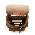 Front Pocket Leather Backpack in Tobacco, top view open with a laptop and books inside