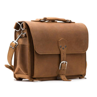 Slim Leather Briefcase in Tobacco, angled front view with buckled flap, top handle and shoulder strap