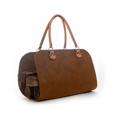 Leather Log Carrier in Tobacco holding firewood, side view with two carry handles
