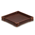 The Leather Grandfather Valet Tray in Chestnut, empty, angled view with riveted corner tabs