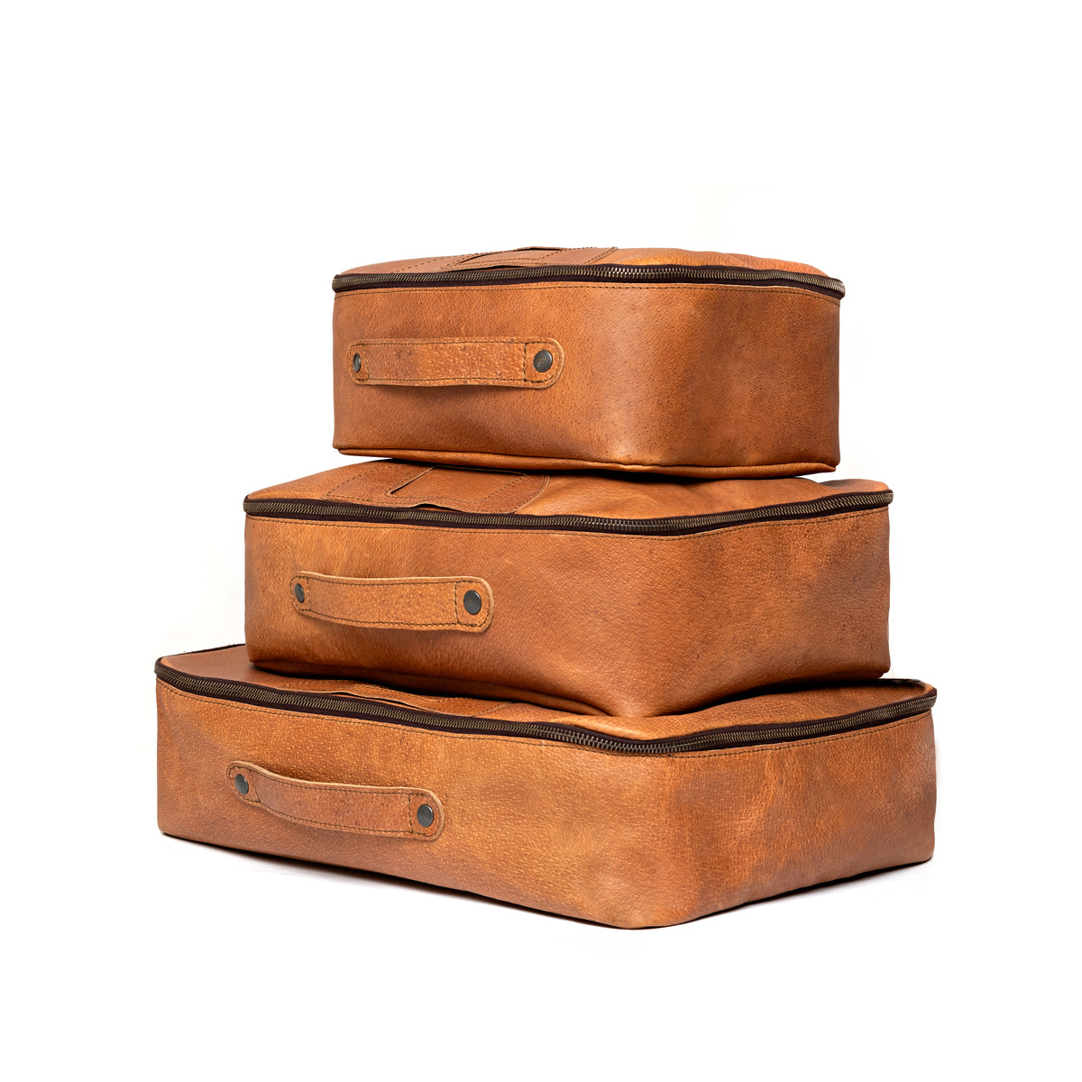 Pigskin Leather Packing Cube Set in small, medium and large sizes stacked with side carry handles