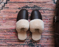 Women's Sheepskin Slippers in Dark Coffee Brown, top-down view of pair on a patterned rug
