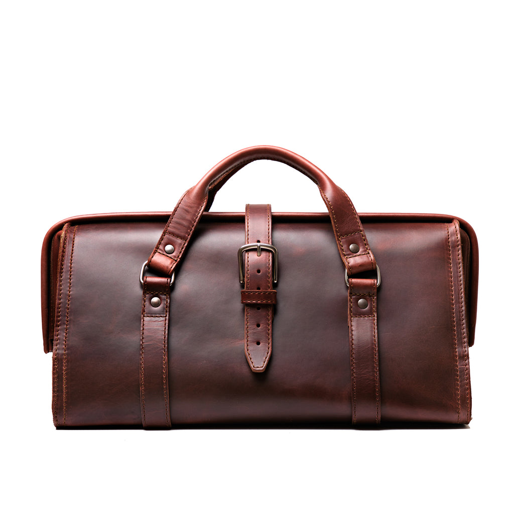 Leather Range and Tool Bag in Chestnut, front view with top handles, center buckle strap and frame opening
