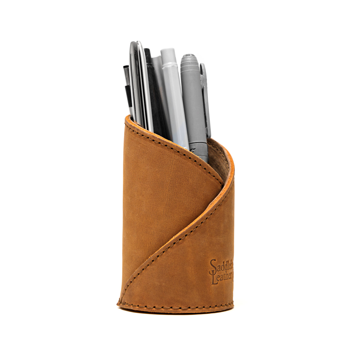 Pen Cup in Tobacco leather with diagonal stitched wrap and embossed Saddleback Leather logo, holding pens