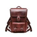 Small Front Pocket Backpack in Chestnut, front view showing the buckled flap, front pocket and shoulder straps