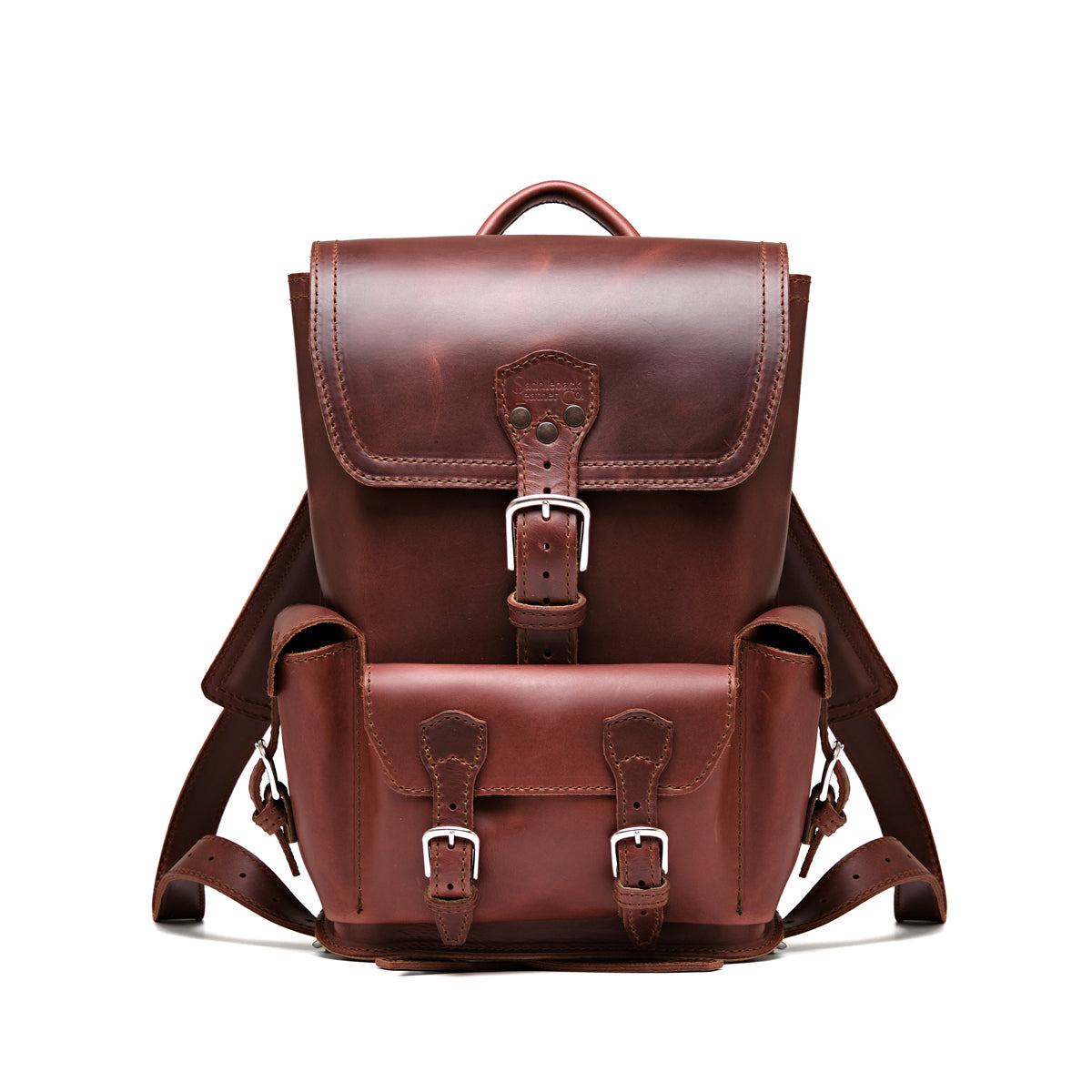 Small Front Pocket Backpack in Chestnut, front view showing the buckled flap, front pocket and shoulder straps
