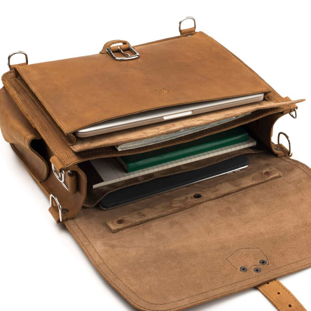 Slim Leather Briefcase in Tobacco, top view with flap open showing a laptop, notebooks and a tablet in the compartments