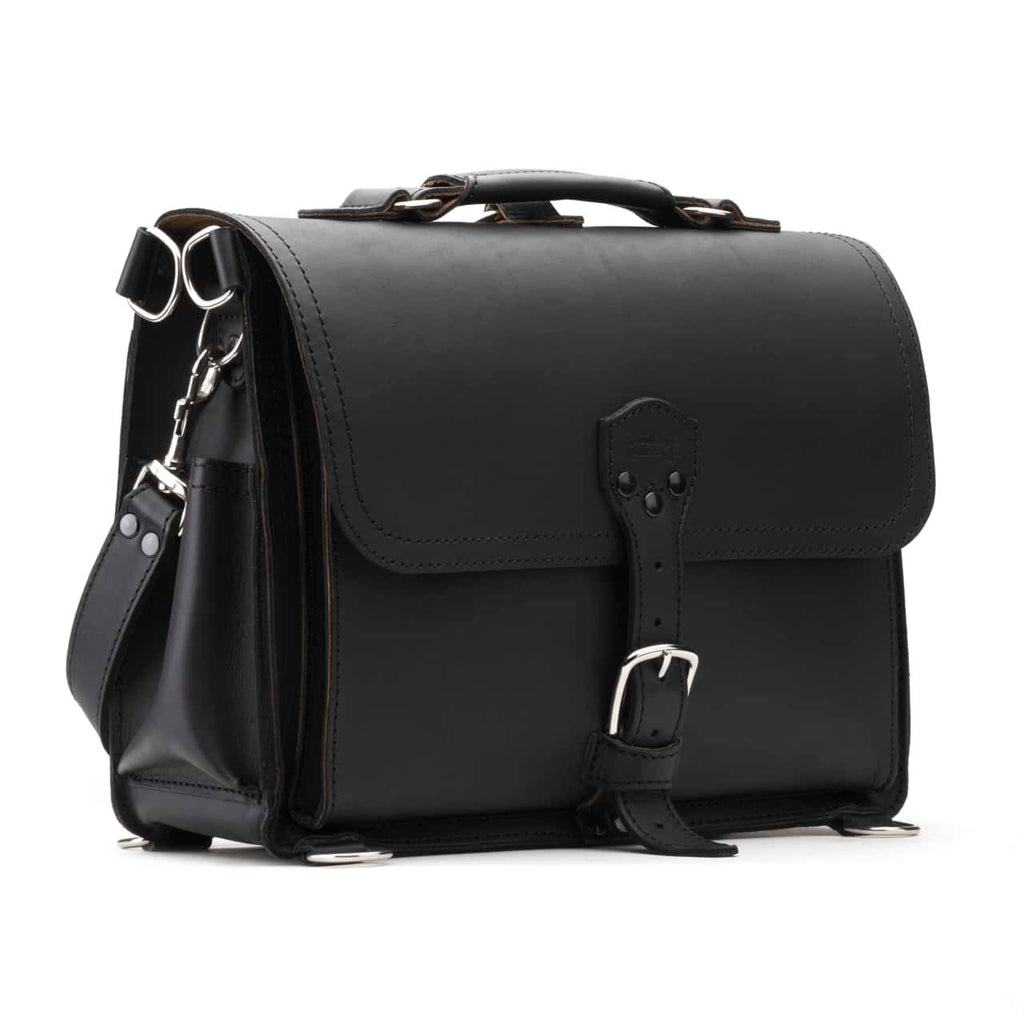 Slim Leather Briefcase in Black, angled front view with buckled flap, top handle and shoulder strap