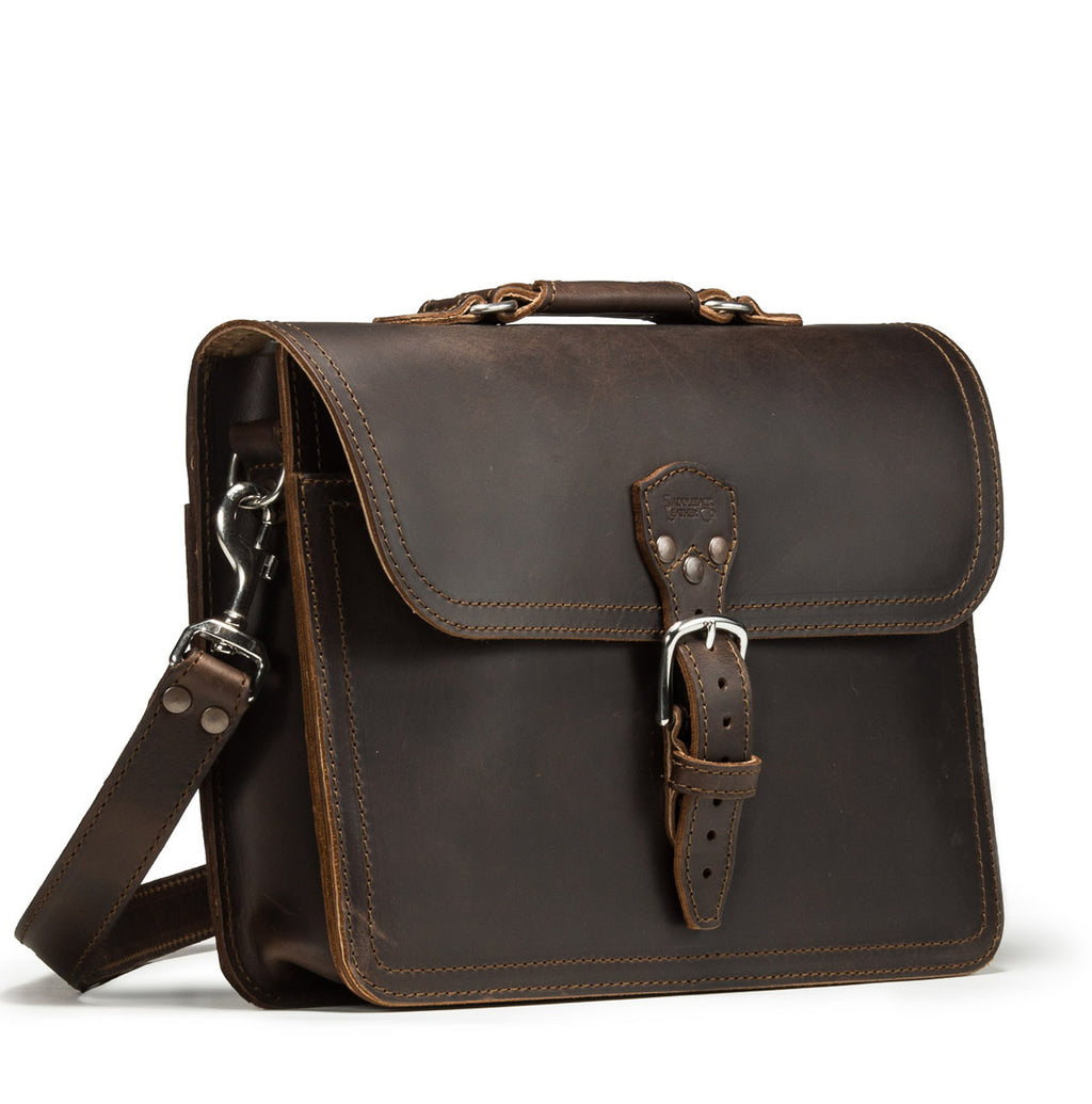 Fourteener Thin Leather Briefcase in Dark Coffee Brown, angled front view with top handle, buckled flap and shoulder strap