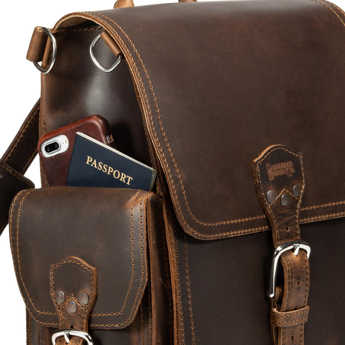 Tank Backpack in Dark Coffee Brown, close-up of side pocket holding a phone and passport