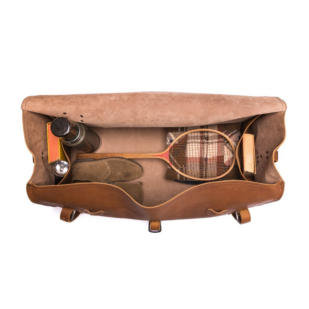 34" Beast Duffle Bag in Tobacco, top view packed with a wooden tennis racket, thermos, shoes and books