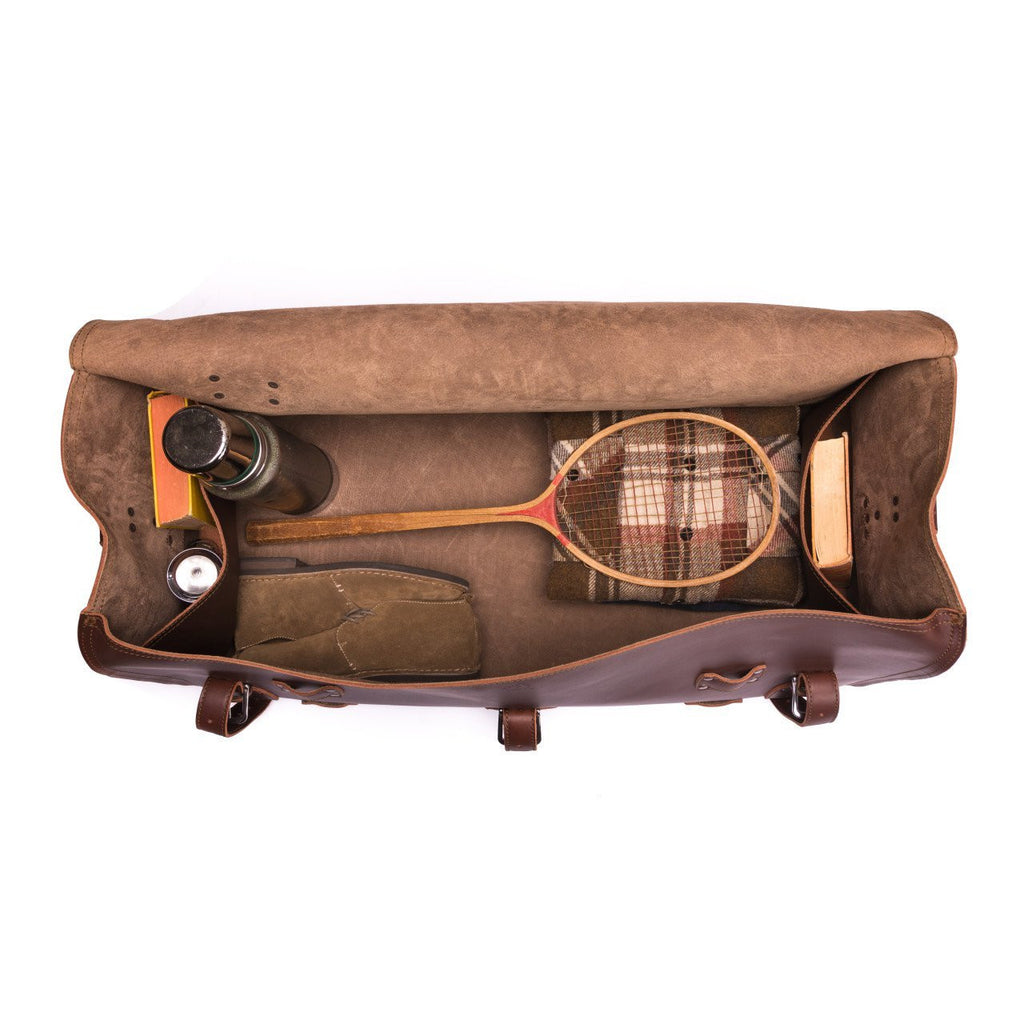 34" Beast Duffle Bag in Chestnut, top view packed with a wooden tennis racket, thermos, shoes and books