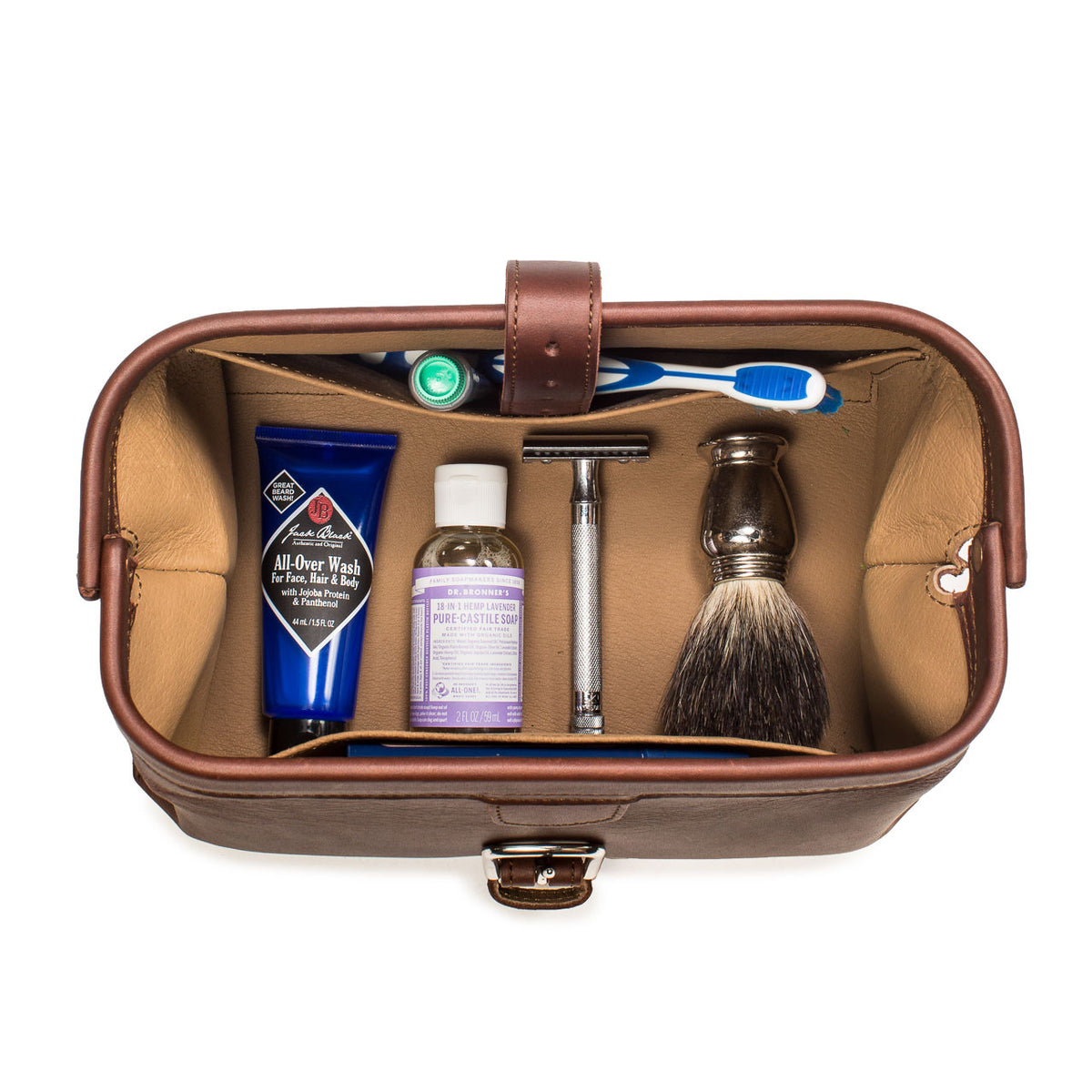 Big Mouth Leather Toiletry Bag in Chestnut, top-down view of open bag holding toothbrush, razor and shaving brush