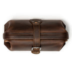 Little Big Mouth Toiletry Bag in Dark Coffee Brown, top view closed with the leather strap buckled over the frame