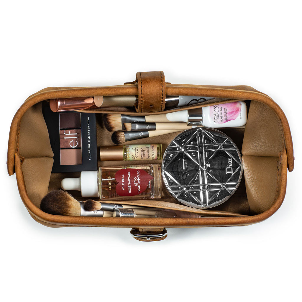 Little Big Mouth Toiletry Bag in Tobacco, top view open and filled with makeup brushes, compacts and cosmetics