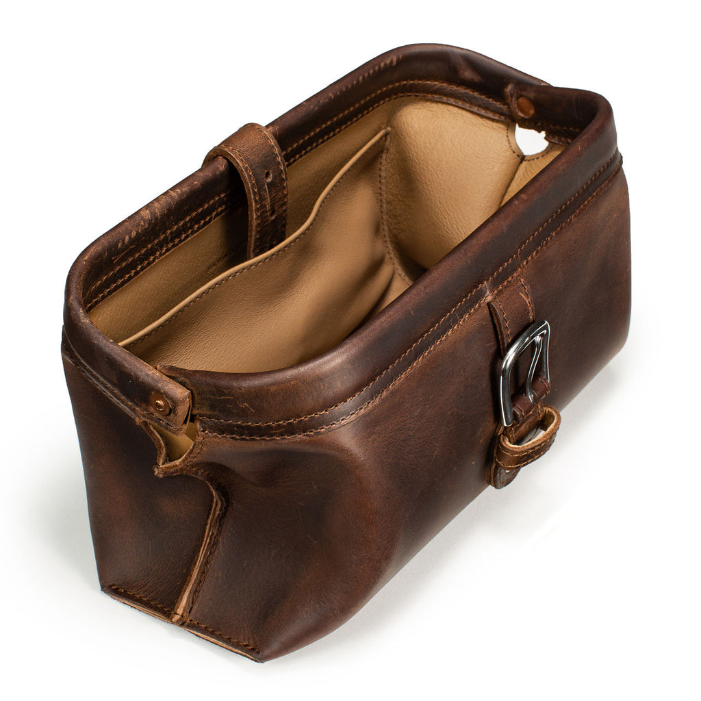 Little Big Mouth Toiletry Bag in Dark Coffee Brown, angled view with the frame mouth open showing the lined interior