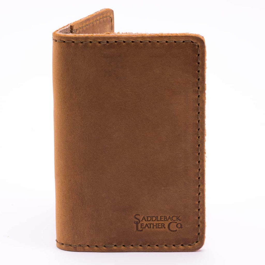Slim Business Card Holder in Tobacco leather, closed close-up showing stitched edges and embossed logo