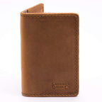 Slim Business Card Holder in Tobacco leather, closed close-up showing stitched edges and embossed logo