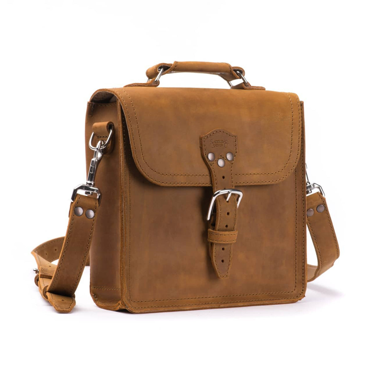 Indiana Leather Satchel in Tobacco, angled front view with buckled flap, top handle and shoulder strap
