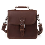 Indiana Leather Satchel in Chestnut, front view with buckled flap, top handle and clipped shoulder strap