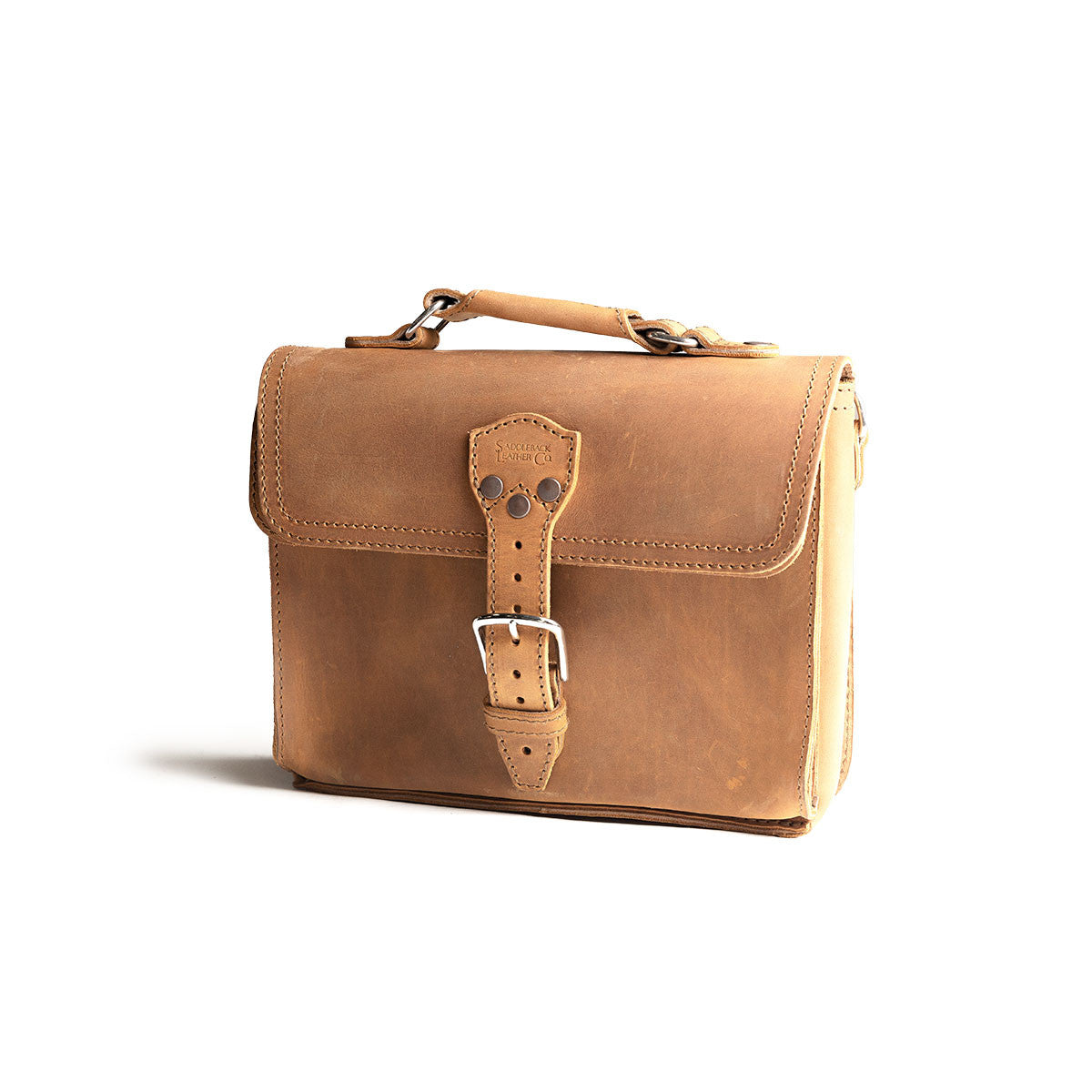 Front Pocket Leather Satchel in Tobacco, three-quarter view showing the strap buckle and stitched front pocket