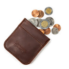 Bear Trap Leather Coin Purse in Chestnut, angled view with coins spilling from the spring-clasp opening