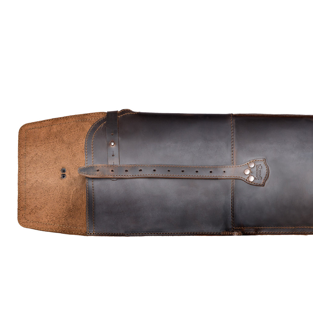 Shotgun Sleeve in Dark Coffee Brown, close-up of the end flap opened to show the suede underside and closure strap