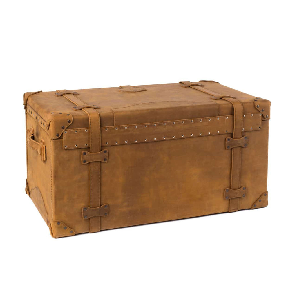 Leather Trunk in Tobacco, closed angled back view with vertical straps, studded trim and side handle