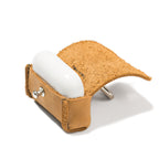 Leather AirPods Pro Case in Tobacco with the flap open and the white charging case inside