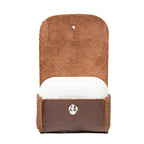 Leather AirPods Pro Case in Chestnut, flap open showing the suede lining and closed charging case inside