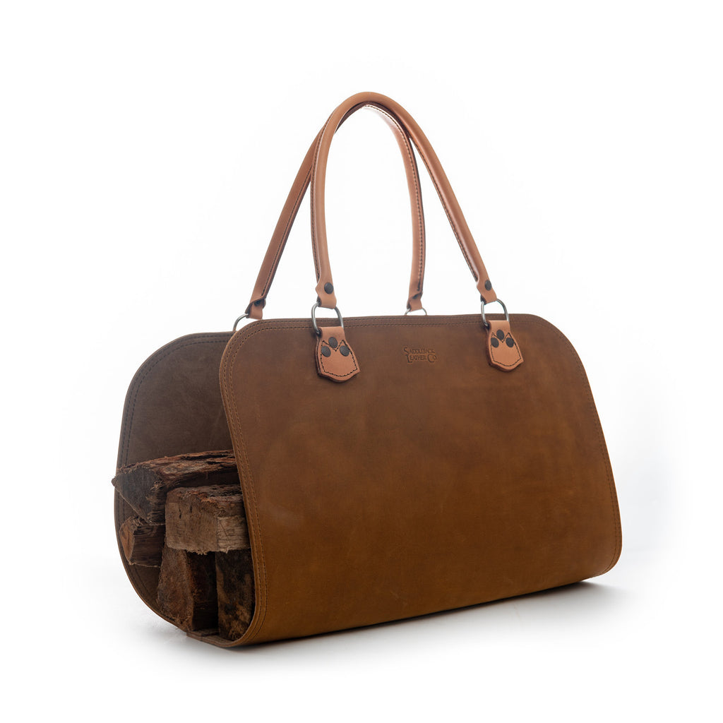 Leather Log Carrier in Tobacco with carry handles, holding firewood, side view