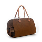 Leather Log Carrier in Tobacco with carry handles, holding firewood, side view