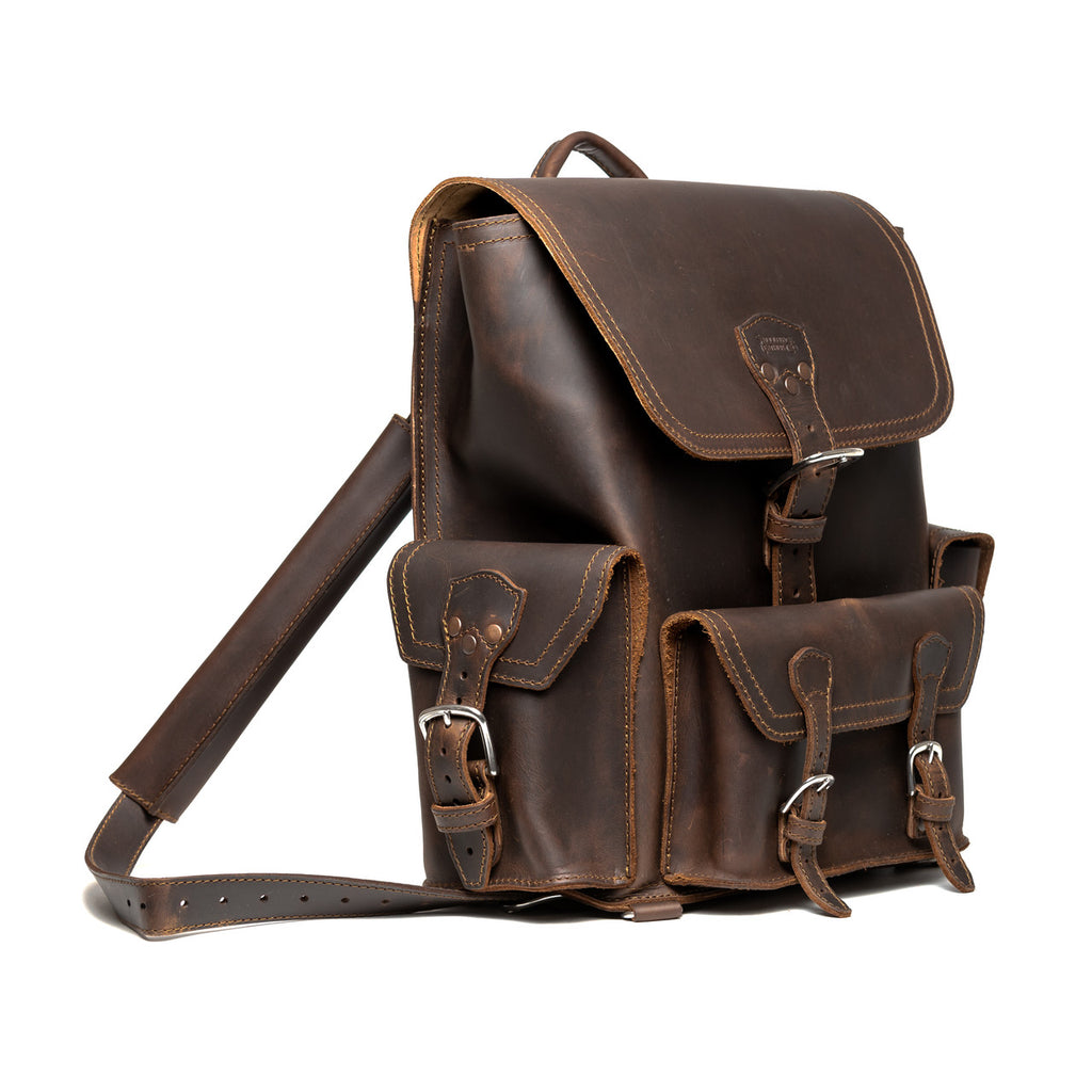 Front Pocket Leather Backpack in Dark Coffee Brown, angled view with buckled flap, front pockets and strap