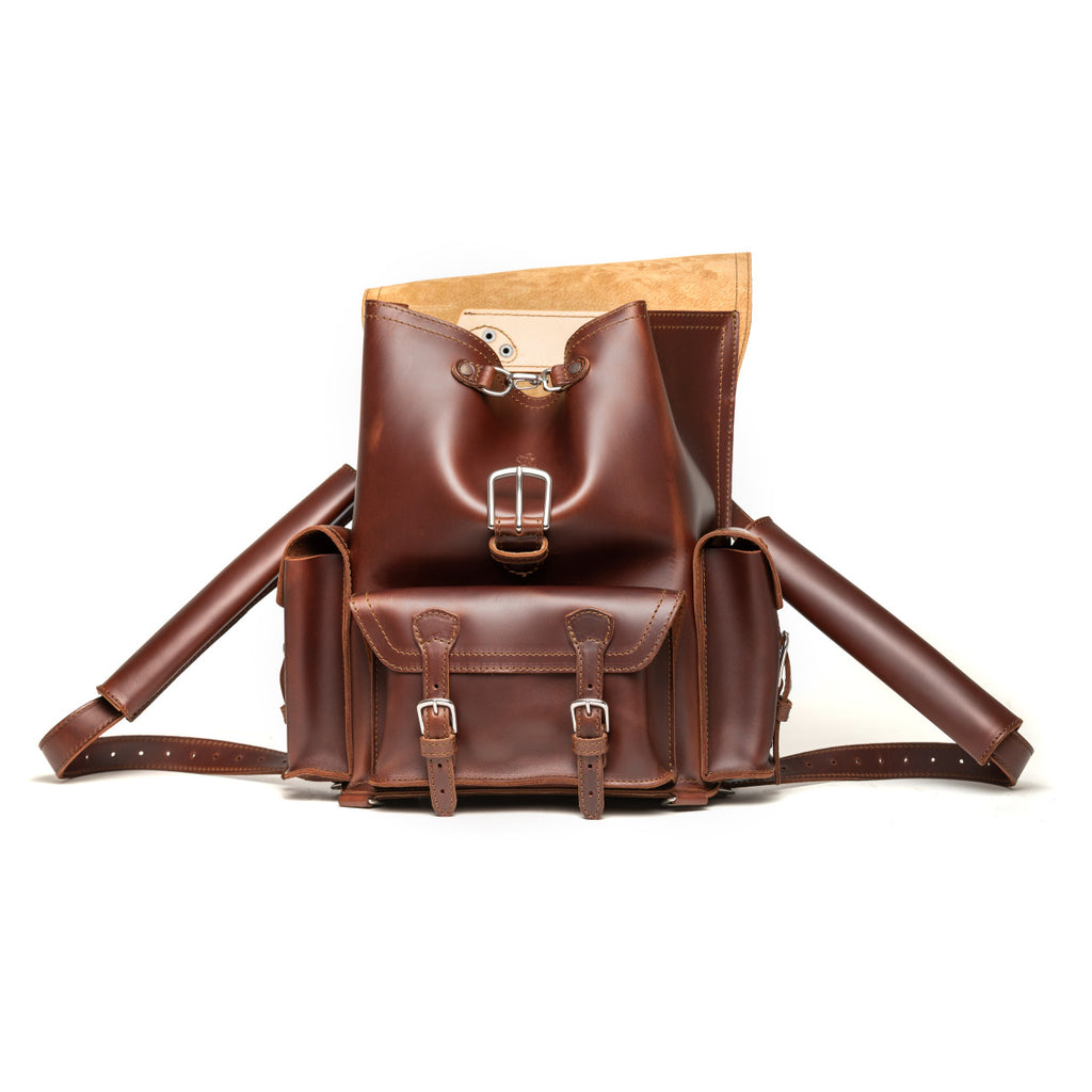 Front Pocket Leather Backpack in Chestnut, front view with flap folded back showing the suede underside
