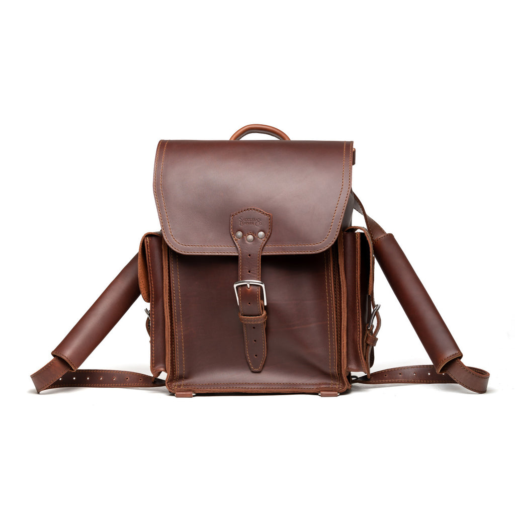 Tank Backpack in Chestnut, front view with buckled flap and side pockets